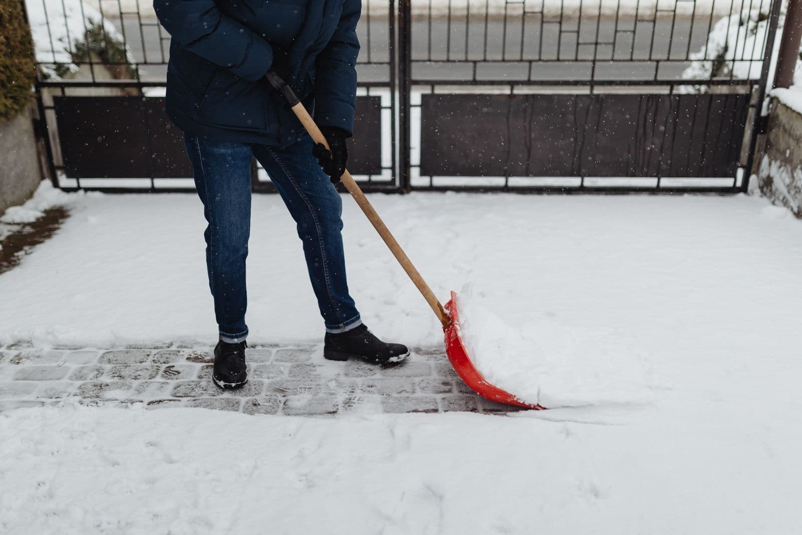 Person shovelling snow from a walkway